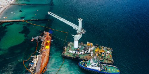 Top view of an old tanker that ran aground and overturned